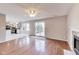 Open-concept living room has a fireplace and walks out to the deck and eat-in kitchen at 5397 Ripplingbrook Way, Carmel, IN 46033