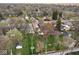 Aerial view of a property with house and yard outlined in red against a backdrop of trees and neighborhood at 5654 Broadway St, Indianapolis, IN 46220