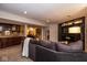 Spacious basement living area with bar and built-in entertainment center at 5654 Broadway St, Indianapolis, IN 46220