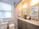 Bathroom with double sinks, marble countertops and updated fixtures at 5654 Broadway St, Indianapolis, IN 46220