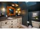 Bathroom highlighting a vanity, a toilet, and dark blue walls at 5654 Broadway St, Indianapolis, IN 46220
