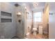 Bathroom with a glass shower, decorative tile and a modern chandelier at 5654 Broadway St, Indianapolis, IN 46220