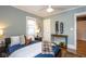 Bedroom with hardwood floors, a ceiling fan, and a skateboard decoration at 5654 Broadway St, Indianapolis, IN 46220