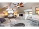 Spacious bedroom featuring a sitting area, carpet, and sloped ceilings at 5654 Broadway St, Indianapolis, IN 46220