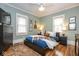 Bedroom with hardwood floors, a ceiling fan, and natural light at 5654 Broadway St, Indianapolis, IN 46220