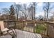 Outdoor deck with chairs overlooking a fenced backyard and garage at 5654 Broadway St, Indianapolis, IN 46220