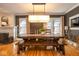 Bright dining room boasting a long wooden table, hardwood floors and modern lighting fixture at 5654 Broadway St, Indianapolis, IN 46220