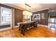 Dining room featuring a large wooden table, hardwood floors, and natural light at 5654 Broadway St, Indianapolis, IN 46220