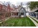Charming two-story home with a well-manicured lawn and mature trees showing it's curb appeal and neighborhood at 5654 Broadway St, Indianapolis, IN 46220