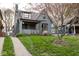 Charming two-story home with a lush front yard and inviting curb appeal showcasing it's quaint architectural details at 5654 Broadway St, Indianapolis, IN 46220