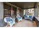 Cozy front porch with wicker furniture and a patterned rug, creating a welcoming outdoor space at 5654 Broadway St, Indianapolis, IN 46220