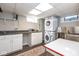 Functional laundry room with updated appliances, storage cabinets, and utility sink at 5654 Broadway St, Indianapolis, IN 46220