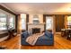 Relaxing living room featuring a fireplace, hardwood floors and a comfortable blue sofa at 5654 Broadway St, Indianapolis, IN 46220