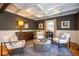 Stylish living room featuring coffered ceilings, hardwood floors, and neutral decor, perfect for relaxation and entertaining at 5654 Broadway St, Indianapolis, IN 46220