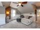 Bright living room featuring a sofa, carpet, and sloped ceilings at 5654 Broadway St, Indianapolis, IN 46220