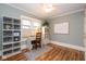 Bright office space with a ceiling fan, a bookshelf, a desk, and beautiful hardwood floors at 5654 Broadway St, Indianapolis, IN 46220