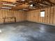 Spacious garage with unfinished walls, workbench and a small window providing natural light at 600 Fairlane Dr, Edinburgh, IN 46124