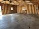 Garage with unfinished interior, exposed beams, and ample space perfect for storage and projects at 600 Fairlane Dr, Edinburgh, IN 46124