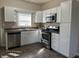 Bright kitchen features stainless steel appliances, white cabinets, and tiled flooring at 600 Fairlane Dr, Edinburgh, IN 46124