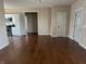 Spacious living room with hardwood floors, connecting to the kitchen at 600 Fairlane Dr, Edinburgh, IN 46124