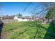 Spacious backyard featuring a fire pit, shed, mature trees, and a fenced perimeter at 617 Kokomo Ln, Indianapolis, IN 46241