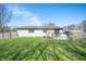Large backyard featuring a deck, fence, mature trees and sunny exposure at 617 Kokomo Ln, Indianapolis, IN 46241