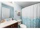 Bright bathroom featuring a vanity, toilet, mirror and a shower/tub combo at 617 Kokomo Ln, Indianapolis, IN 46241