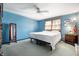 Bedroom with a ceiling fan, neutral carpet, light-filled window and blue walls at 617 Kokomo Ln, Indianapolis, IN 46241