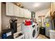 Laundry room featuring a washer and dryer, shelving, storage and utility sink at 617 Kokomo Ln, Indianapolis, IN 46241