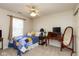 Well-lit bedroom featuring a ceiling fan, dresser, and a comfortable bed with colorful quilt at 6174 Bristlecone Dr, Fishers, IN 46038