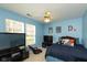 Cozy bedroom featuring dual TVs, comfortable seating, and natural light at 6174 Bristlecone Dr, Fishers, IN 46038
