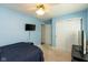 Well-lit bedroom featuring a ceiling fan, closet, and entertainment setup at 6174 Bristlecone Dr, Fishers, IN 46038