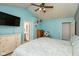 Comfortable bedroom with blue walls, vaulted ceiling, ceiling fan and ensuite bathroom at 6174 Bristlecone Dr, Fishers, IN 46038