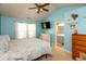 Tranquil bedroom with blue walls, vaulted ceiling, ceiling fan and ensuite bathroom at 6174 Bristlecone Dr, Fishers, IN 46038