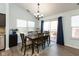 Bright dining room with modern chandelier, natural light, and sliding glass doors leading to outdoor space at 6174 Bristlecone Dr, Fishers, IN 46038