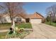 Charming ranch home with a well-manicured lawn, beautiful landscaping, and an attached two-car garage at 6174 Bristlecone Dr, Fishers, IN 46038