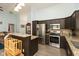 Well-equipped kitchen featuring stainless steel appliances, dark cabinets, and granite countertops at 6174 Bristlecone Dr, Fishers, IN 46038