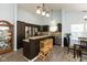 Modern kitchen with stainless steel appliances, granite countertops, dark cabinets, and hardwood floors at 6174 Bristlecone Dr, Fishers, IN 46038