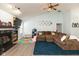 Comfortable living room featuring a fireplace, large sectional sofa, and bright, sky blue walls at 6174 Bristlecone Dr, Fishers, IN 46038