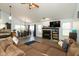 Spacious living room with a fireplace, hardwood floors, vaulted ceiling, and natural light at 6174 Bristlecone Dr, Fishers, IN 46038