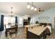 Open layout connecting the kitchen, dining area, and living room with hardwood flooring and vaulted ceiling at 6174 Bristlecone Dr, Fishers, IN 46038