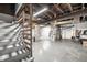 Spacious unfinished basement with concrete floor, exposed ductwork, and stairway at 622 E 37Th St, Indianapolis, IN 46205