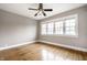 Sunlit bedroom with hardwood floors, neutral walls, and multiple windows at 622 E 37Th St, Indianapolis, IN 46205