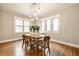 Bright dining room featuring a modern lighting fixture and large windows at 622 E 37Th St, Indianapolis, IN 46205