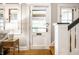 Bright entryway featuring a white door, natural wood floors, and traditional staircase at 622 E 37Th St, Indianapolis, IN 46205