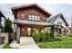 Inviting craftsman home with a yellow door, mature landscaping, and classic architectural design at 622 E 37Th St, Indianapolis, IN 46205