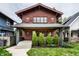 Charming craftsman-style home with a red-toned exterior, front porch, and well-manicured lawn at 622 E 37Th St, Indianapolis, IN 46205