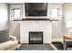Stylish fireplace with a TV, white mantel, dark brick hearth, and neutral-toned furnishings at 622 E 37Th St, Indianapolis, IN 46205