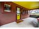 Welcoming front porch with a bright yellow door, and classic architectural detailing at 622 E 37Th St, Indianapolis, IN 46205