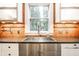 Close up of kitchen sink area showing backsplash and faucet with natural light at 622 E 37Th St, Indianapolis, IN 46205